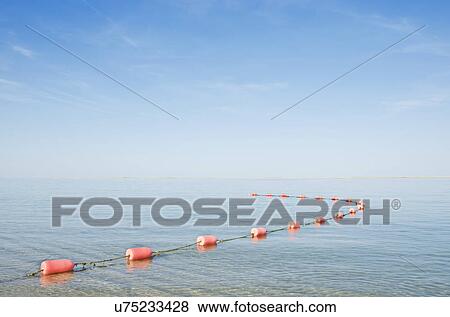 Rope with buoys on calm sea View Large Photo Image Stock Photo - Rope with buoys on calm sea. Fotosearch