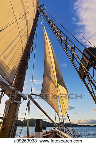 Sail and ropes against sunset sky View Large Photo Image Stock Photo - Sail and ropes against sunset sky. Fotosearch