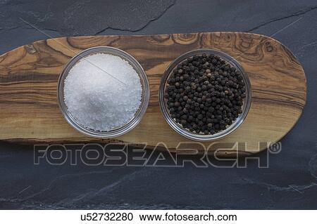 Stock Image - Salt and pepper on wood. Fotosearch