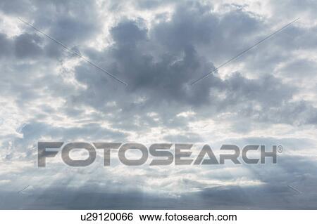 Stock Photograph - Scenic cloudscape with sunbeams. Fotosearch