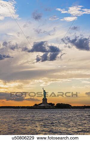 Silhouette of Statue of Liberty at sunset View Large Photo Image Stock Photo - Silhouette of Statue of Liberty at sunset. Fotosearch