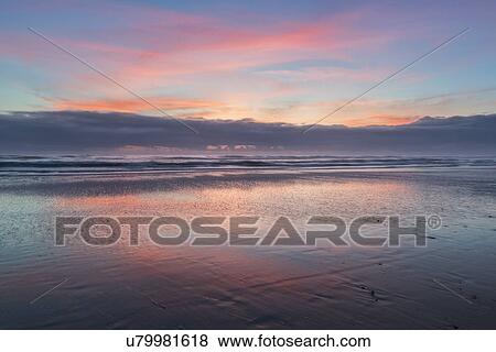 Stock Photo - Sky reflecting in water at sunset. Fotosearch