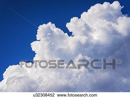 Stock Image - Soft white cloud on blue sky. Fotosearch
