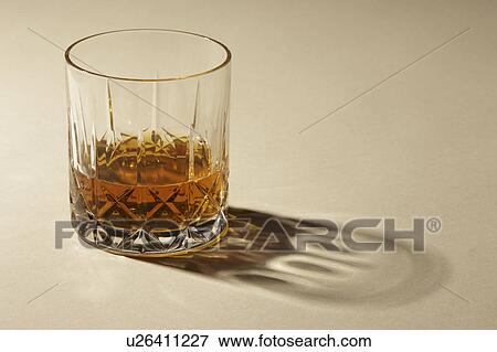 Studio shot of glass with alcohol View Large Photo Image Stock Photo - Studio shot of glass with alcohol. Fotosearch