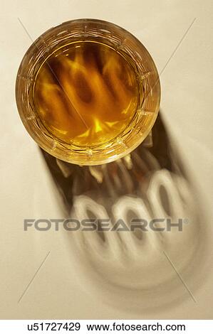 Stock Photo - Studio shot of glass with alcohol. Fotosearch