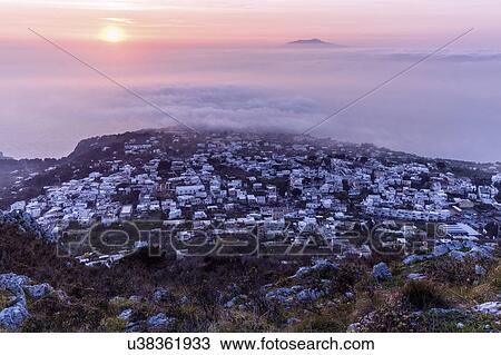 Stock Image - Town at sunset. Fotosearch