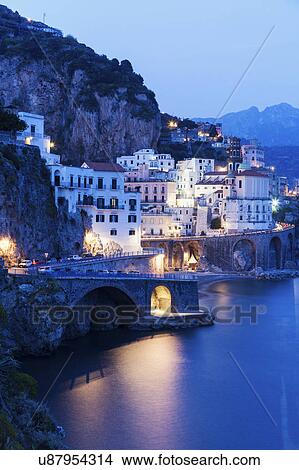 Picture - Town on coastline at dusk. Fotosearch