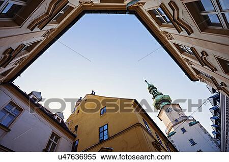 Townhouses and tower against sky View Large Photo Image Stock Photography - Townhouses and tower against sky. Fotosearch