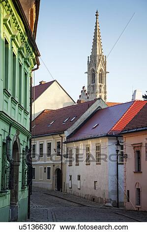 Townhouses with church tower in background View Large Photo Image Stock Photo - Townhouses with church tower in background. Fotosearch