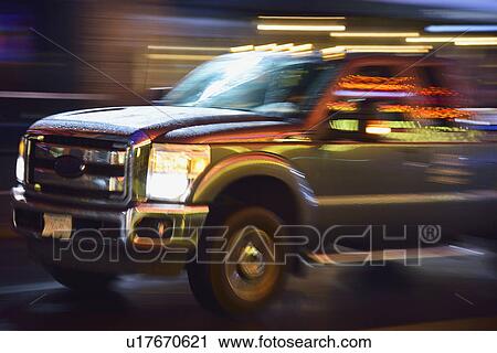 Truck in illuminated city street, in motion at night View Large Photo Image Stock Image - Truck in illuminated city street, in motion at night. Fotosearch