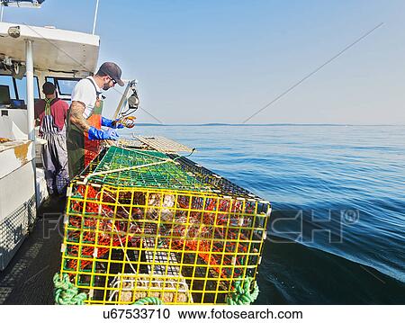Two fishermen working on boat View Large Photo Image Stock Image - Two fishermen working on boat. Fotosearch