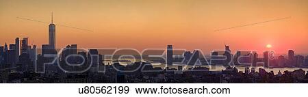 Waterfront cityscape under golden sky at sunset View Large Photo Image Stock Photo - Waterfront cityscape under golden sky at sunset. Fotosearch