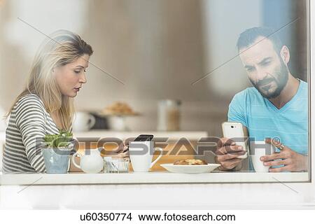 Picture - Woman and man using telephones. Fotosearch