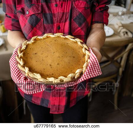 Woman holding baked pumpkin pie for Thanksgiving View Large Photo Image Stock Photography - Woman holding baked pumpkin pie for Thanksgiving. Fotosearch