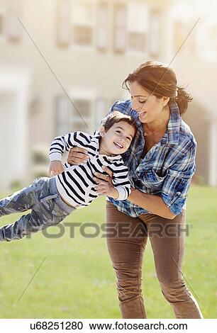 Stock Image - Woman playing with son (2-3). Fotosearch