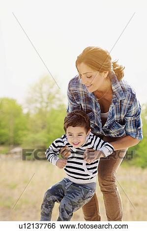Woman playing with son (2-3) View Large Photo Image Stock Photograph - Woman playing with son (2-3). Fotosearch