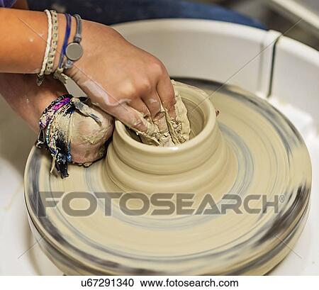 Woman shaping clay bowl on pottery wheel View Large Photo Image Stock Image - Woman shaping clay bowl on pottery wheel. Fotosearch
