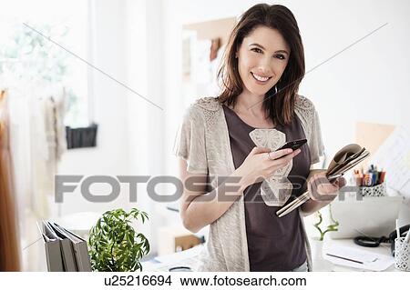Picture - Young woman looking at camera. Fotosearch