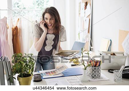 Picture - Young woman talking on phone. Fotosearch
