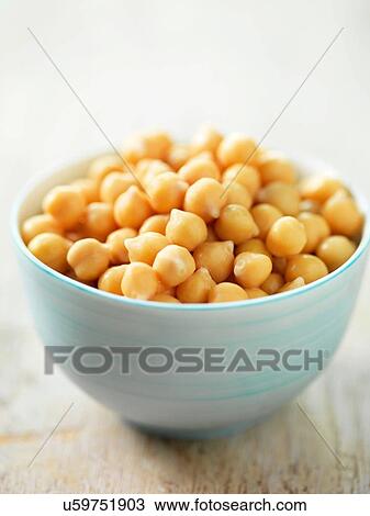 Stock Image - Chick peas in white bowl. Fotosearch