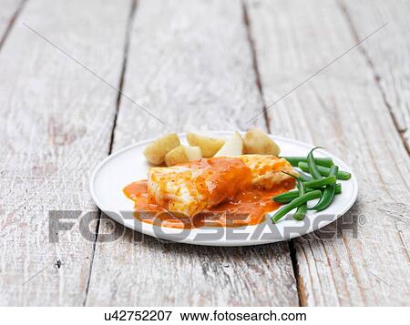 Cod fillets with a tomato and herb sauce served with green beans and new potatoes View Large Photo Image Stock Photo - Cod fillets with a tomato and herb sauce served with green beans and new potatoes. Fotosearch