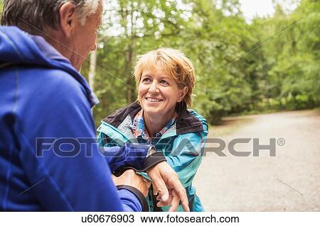 Couple on pathway in forest, face to face, smiling View Large Photo Image Stock Image - Couple on pathway in forest, face to face, smiling. Fotosearch