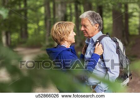 Couple standing face to face in forest View Large Photo Image Stock Photograph - Couple standing face to face in forest. Fotosearch