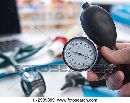 Stock Photo - Doctor holding otoscope. Fotosearch