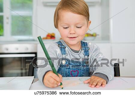 Female toddler drawing at kitchen table View Large Photo Image Stock Photograph - Female toddler drawing at kitchen table. Fotosearch