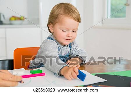 Female toddler using eraser whilst drawing at kitchen table View Large Photo Image Stock Image - Female toddler using eraser whilst drawing at kitchen table. Fotosearch