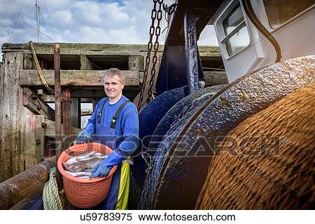 Fisherman with nets on stern of trawler, portrait View Large Photo Image Stock Photography - Fisherman with nets on stern of trawler, portrait. Fotosearch