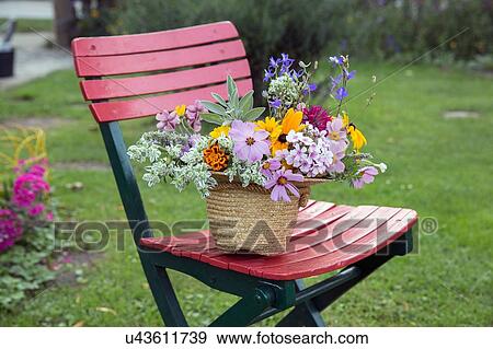 Fresh cut flowers in straw hat, on garden chair View Large Photo Image Stock Photo - Fresh cut flowers in straw hat, on garden chair. Fotosearch