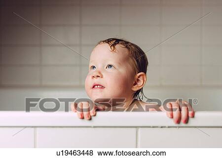Girl with wet hair in bath holding onto edge looking away View Large Photo Image Stock Photo - Girl with wet hair in bath holding onto edge looking away. Fotosearch