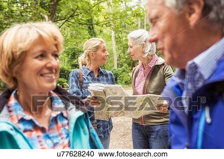 Group of friends on hiking trail, looking at map View Large Photo Image Stock Image - Group of friends on hiking trail, looking at map. Fotosearch
