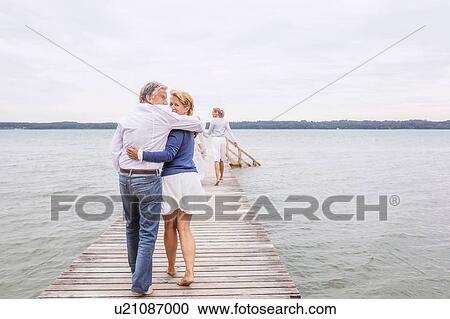 Group of friends walking on pier, rear view View Large Photo Image Stock Image - Group of friends walking on pier, rear view. Fotosearch