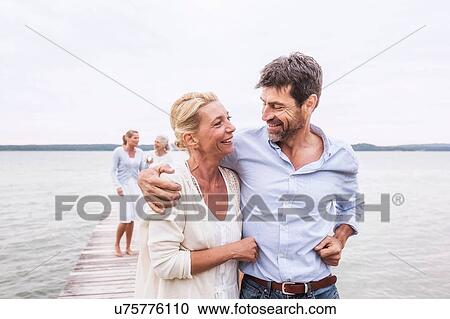 Group of friends walking on pier View Large Photo Image Stock Image - Group of friends walking on pier. Fotosearch