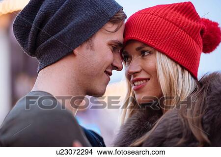Head and shoulder shot of romantic young couple wearing knit hats View Large Photo Image Picture - Head and shoulder shot of romantic young couple wearing knit hats. Fotosearch