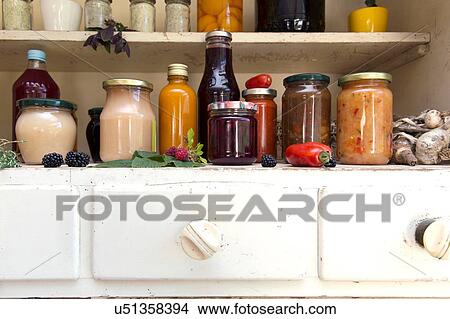 Jars and bottles of home-made food on retro style kitchen cabinet View Large Photo Image Picture - Jars and bottles of home-made food on retro style kitchen cabinet. Fotosearch