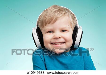 Little boy wearing headphones and smiling View Large Photo Image Stock Photo - Little boy wearing headphones and smiling. Fotosearch