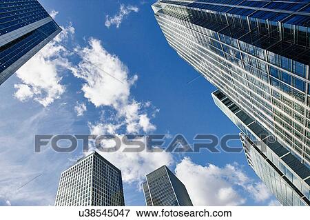 Stock Photo - Low angle view of skyscrapers and blue sky, Canary Wharf, London, UK. Fotosearch