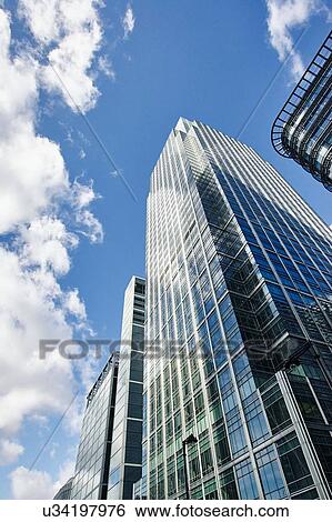 Stock Photograph - Low angle view of skyscrapers and blue sky, Canary Wharf, London, UK. Fotosearch