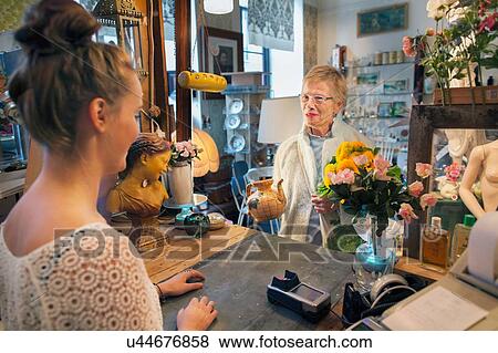 Mature female customer buying teapot in vintage shop View Large Photo Image Stock Photo - Mature female customer buying teapot in vintage shop. Fotosearch