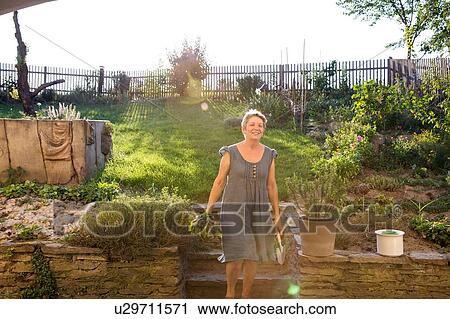 Mature woman gardening, digging up fresh vegetables View Large Photo Image Stock Image - Mature woman gardening, digging up fresh vegetables. Fotosearch