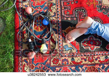 Overhead view of womans bare feet and decorative lights on rug in park View Large Photo Image Stock Image - Overhead view of womans bare feet and decorative lights on rug in park. Fotosearch