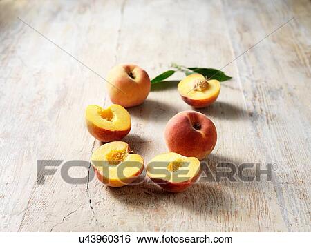 Peaches, halved and whole View Large Photo Image Stock Photograph - Peaches, halved and whole. Fotosearch
