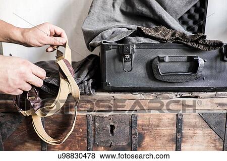 Stock Photo - Photographer getting equipment ready, close-up. Fotosearch