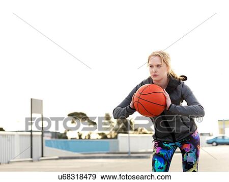 Portrait fo young female basketball player practicing throw in parking lot View Large Photo Image Stock Photo - Portrait fo young female basketball player practicing throw in parking lot. Fotosearch