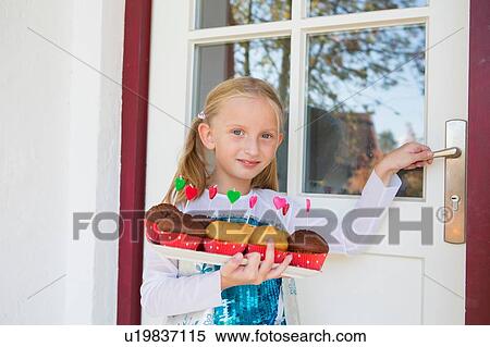 Portrait of girl carrying cakes on patio View Large Photo Image Stock Photography - Portrait of girl carrying cakes on patio. Fotosearch