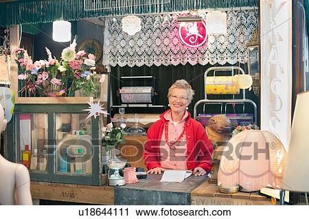 Portrait of mature woman behind vintage shop counter View Large Photo Image Stock Image - Portrait of mature woman behind vintage shop counter. Fotosearch