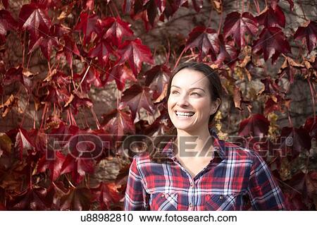 Stock Image - Portrait of mid adult woman at Thornbury Castle, South Gloucestershire, UK. Fotosearch